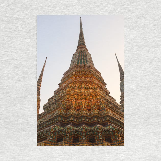 Low angle view of a Buddha stupa reaching symmetrical in the clear sky. by kall3bu